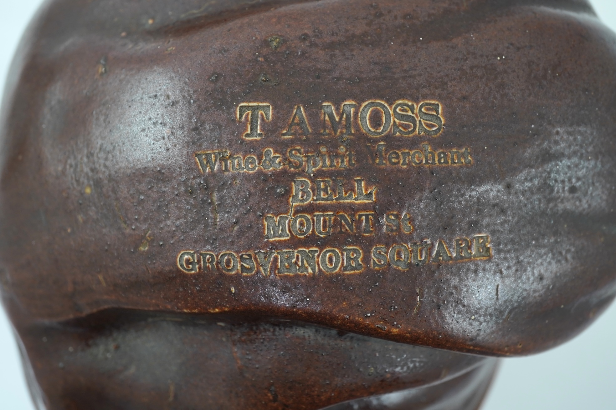 A large 19th century Johnny Souter, salt glazed stoneware spirit flask impressed T A Moss wine and spirit Merchant Bell Mount street Grosvenor square, 28cm high